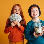 excited-little-redhead-children-holding-money